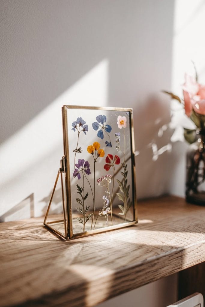 Miniature pressed flower frame with brass edges