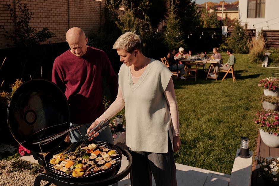 couple grilling vegetables at a backyard barbecue in summer
