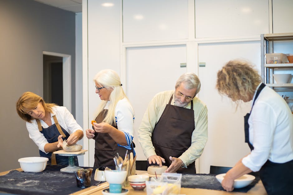 people engaged in a pottery workshop crafting bowls together