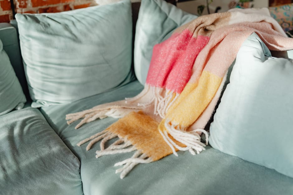 A cozy throw blanket on a sofa, a comfort Father's Day gift for step dad