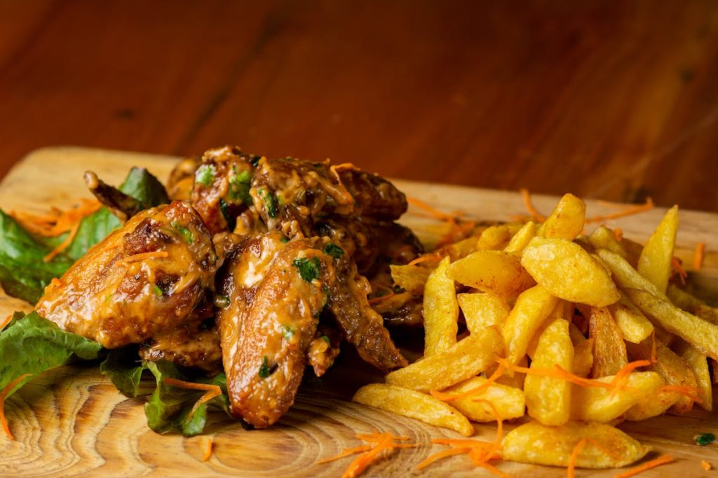 Platter of chicken wings and fries, a classic handheld watch party food