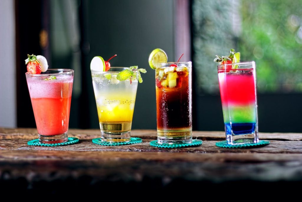 Colorful signature cocktails on a table for a watch party drink station