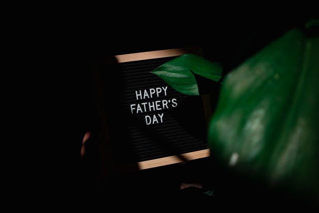 A wrapped Father's Day gift next to a greeting card on a table