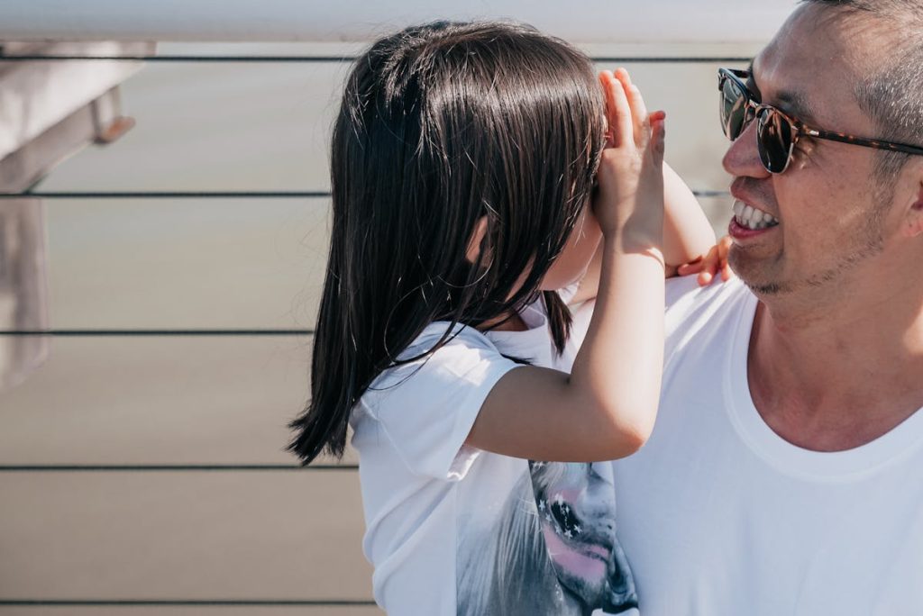 A father and his daughter laughing together outdoors
